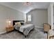 Inviting bedroom featuring a patterned bedspread, modern lamps, and comfortable carpeting at 3460 Montebello Pkwy, Cumming, GA 30028