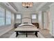 A Primary bedroom with tray ceilings, plantation shutters, and stylish decor at 3460 Montebello Pkwy, Cumming, GA 30028