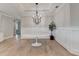 Dining area featuring an elegant chandelier, wainscoting, and a sleek oval table at 3460 Montebello Pkwy, Cumming, GA 30028