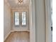 Bright foyer featuring hardwood floors and double doors with plantation shutters at 3460 Montebello Pkwy, Cumming, GA 30028