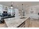 Open concept kitchen featuring granite countertops, stainless steel appliances, and an island at 3460 Montebello Pkwy, Cumming, GA 30028