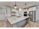 Modern kitchen with granite counters, stainless steel appliances, and custom cabinets offers ample storage at 3460 Montebello Pkwy, Cumming, GA 30028