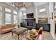 Stylish living room with fireplace, hardwood floors, and large windows allowing ample natural light at 3460 Montebello Pkwy, Cumming, GA 30028