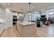 A spacious kitchen flows into the living room with a fireplace and abundant natural light at 3460 Montebello Pkwy, Cumming, GA 30028