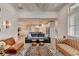 Bright living room featuring stylish decor, hardwood floors, and seamless flow to the kitchen at 3460 Montebello Pkwy, Cumming, GA 30028