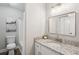 Bright bathroom featuring tiled shower, granite countertop, and vanity at 6693 Doublegate Ln, Rex, GA 30273