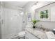 Clean bathroom with tiled shower, granite countertop, and modern fixtures at 6693 Doublegate Ln, Rex, GA 30273