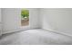 Neutral bedroom with carpet, a window letting in light, and neutral walls at 6693 Doublegate Ln, Rex, GA 30273