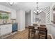 Bright dining area features modern lighting, new floors, and a refreshing view to the backyard at 6693 Doublegate Ln, Rex, GA 30273