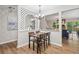 Dining area with new floors, modern lighting, and a seamless view to the living room at 6693 Doublegate Ln, Rex, GA 30273