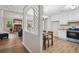 Open-concept dining room with a view to the kitchen and the living room with a fireplace at 6693 Doublegate Ln, Rex, GA 30273