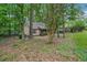 Exterior of a cozy home surrounded by lush trees and greenery, offering privacy at 6693 Doublegate Ln, Rex, GA 30273