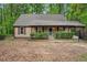 Front of a charming single story home with a covered porch, shrubs, and trimmed bushes at 6693 Doublegate Ln, Rex, GA 30273