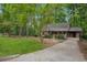 Charming home with a long driveway and a lush green yard surrounded by mature trees at 6693 Doublegate Ln, Rex, GA 30273