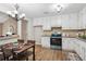 Open kitchen and dining area with matching appliances, white cabinetry, and new laminate floors at 6693 Doublegate Ln, Rex, GA 30273