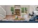 Cozy living room with stone fireplace, wood floors, and access to a deck at 6693 Doublegate Ln, Rex, GA 30273