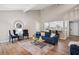 Inviting living room with vaulted ceilings, wood floors, and seamless flow into the kitchen at 6693 Doublegate Ln, Rex, GA 30273