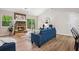 Cozy living room featuring a stone fireplace, wood laminate flooring, and natural light at 6693 Doublegate Ln, Rex, GA 30273