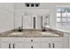 Bathroom with double granite vanity, and large mirror at 990 Lilac Arbor Rd, Dacula, GA 30019
