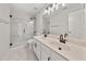 Elegant bathroom with double vanity, marble floors, and glass-enclosed shower at 990 Lilac Arbor Rd, Dacula, GA 30019