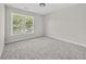Bright bedroom with a large window and neutral carpet at 990 Lilac Arbor Rd, Dacula, GA 30019