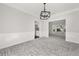 Open dining room with modern chandelier and decorative wall trim at 990 Lilac Arbor Rd, Dacula, GA 30019
