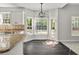 Bright eat-in kitchen featuring granite countertops, stainless appliances, and backyard access at 990 Lilac Arbor Rd, Dacula, GA 30019