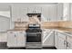 Well-lit kitchen features stainless steel appliances and white cabinets at 990 Lilac Arbor Rd, Dacula, GA 30019