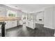 Open concept kitchen features white cabinets, granite countertops, and stainless appliances at 990 Lilac Arbor Rd, Dacula, GA 30019