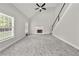 Bright living room with tall ceilings, fireplace, staircase and large windows at 990 Lilac Arbor Rd, Dacula, GA 30019