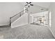 Open-concept living room with staircase and view of the eat-in kitchen and breakfast area at 990 Lilac Arbor Rd, Dacula, GA 30019