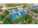 Aerial shot featuring tennis courts and a pool within a neighborhood setting with manicured landscaping at 1354 Benbrooke Nw Ln, Acworth, GA 30101