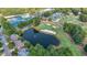 Aerial view showcasing a scenic community with a pond, golf course, clubhouse, and tennis courts at 1354 Benbrooke Nw Ln, Acworth, GA 30101