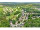 Aerial view showcasing the community, golf course, and surrounding lush greenery at 1354 Benbrooke Nw Ln, Acworth, GA 30101