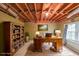 Home office in the basement with exposed ceiling, a bookcase, and a large desk at 1354 Benbrooke Nw Ln, Acworth, GA 30101