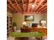 Partially finished basement featuring exposed ceiling, hardwood desk, and built-in bookshelf at 1354 Benbrooke Nw Ln, Acworth, GA 30101