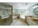 Relaxing bathroom featuring a soaking tub, glass-enclosed shower, and dual vanities at 1354 Benbrooke Nw Ln, Acworth, GA 30101
