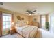 Neutral bedroom with ceiling fan, two windows, and decor, virtually staged at 1354 Benbrooke Nw Ln, Acworth, GA 30101