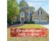 Charming two-story home features a well-manicured lawn, stone accents, and a two-car garage at 1354 Benbrooke Nw Ln, Acworth, GA 30101