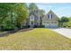 Inviting two-story home with stone and siding, mature trees, and a well-kept front yard at 1354 Benbrooke Nw Ln, Acworth, GA 30101