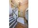 Elegant foyer featuring a grand staircase, chandelier, and hardwood floors at 1354 Benbrooke Nw Ln, Acworth, GA 30101