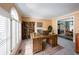 Bright home office with a large window, rustic desk, and a view into the adjacent dining area at 1354 Benbrooke Nw Ln, Acworth, GA 30101