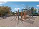 A vibrant community playground with swings and climbing structures, set on a wood chip base under a blue sky at 1354 Benbrooke Nw Ln, Acworth, GA 30101