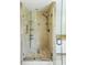 Modern shower with glass enclosure, tile surround, and built-in shelving at 1354 Benbrooke Nw Ln, Acworth, GA 30101
