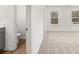 Bright and airy bathroom with double vanity, wood floors, and tiled shower with glass door at 229 Kenoot Dr # 49, Mcdonough, GA 30253