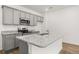 Modern kitchen with gray cabinets, stainless steel appliances, and granite countertops at 229 Kenoot Dr # 49, Mcdonough, GA 30253