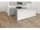 Open kitchen featuring gray cabinets, stainless steel appliances, granite countertops, and wood-look flooring at 229 Kenoot Dr # 49, Mcdonough, GA 30253