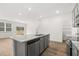 Open concept kitchen with gray cabinets, stainless appliances, and a view to the living area at 229 Kenoot Dr # 49, Mcdonough, GA 30253