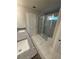 Modern bathroom featuring double granite vanity and glass-enclosed shower with marble tile surround at 3089 Corbin Ave, Decatur, GA 30034