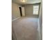 Unfinished bedroom featuring neutral walls, trim, and large window providing natural light at 3089 Corbin Ave, Decatur, GA 30034